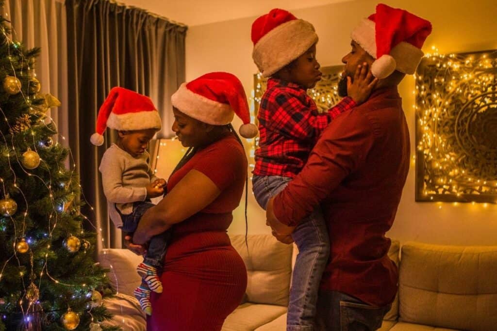 family at Christmas with santa hats on